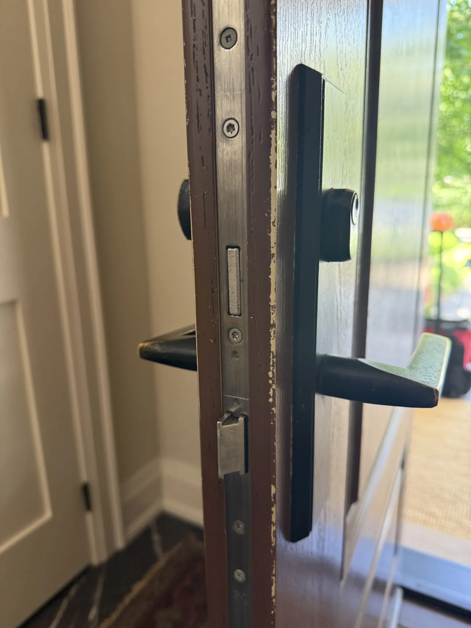 Locksmith rekeying a residential deadbolt on a Burlington home